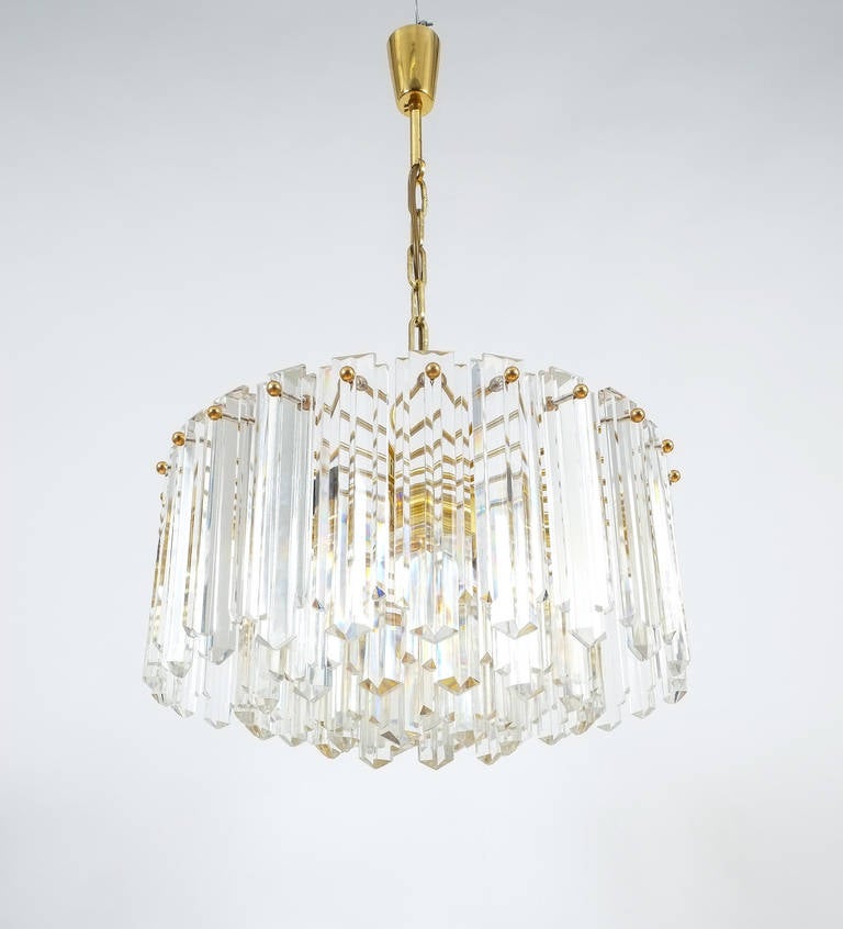 J.T. Kalmar Tiered Crystal Glass and Gold Brass Chandelier Lamp, Austria 1960. Stunning three-tier chandelier in excellent condition. Measuring approximately 20 inches in diameter this chandelier holds up to 13 bulbs (12x e14 with 40W max and 1x e27