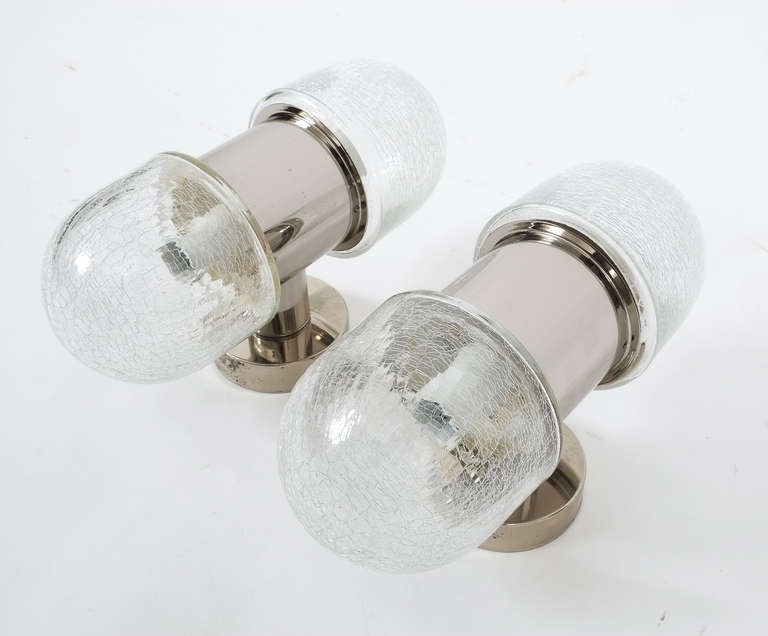 Nice pair of nautical sconces chrome and textured glass sconces featuring two bulbs each. The condition is excellent.
