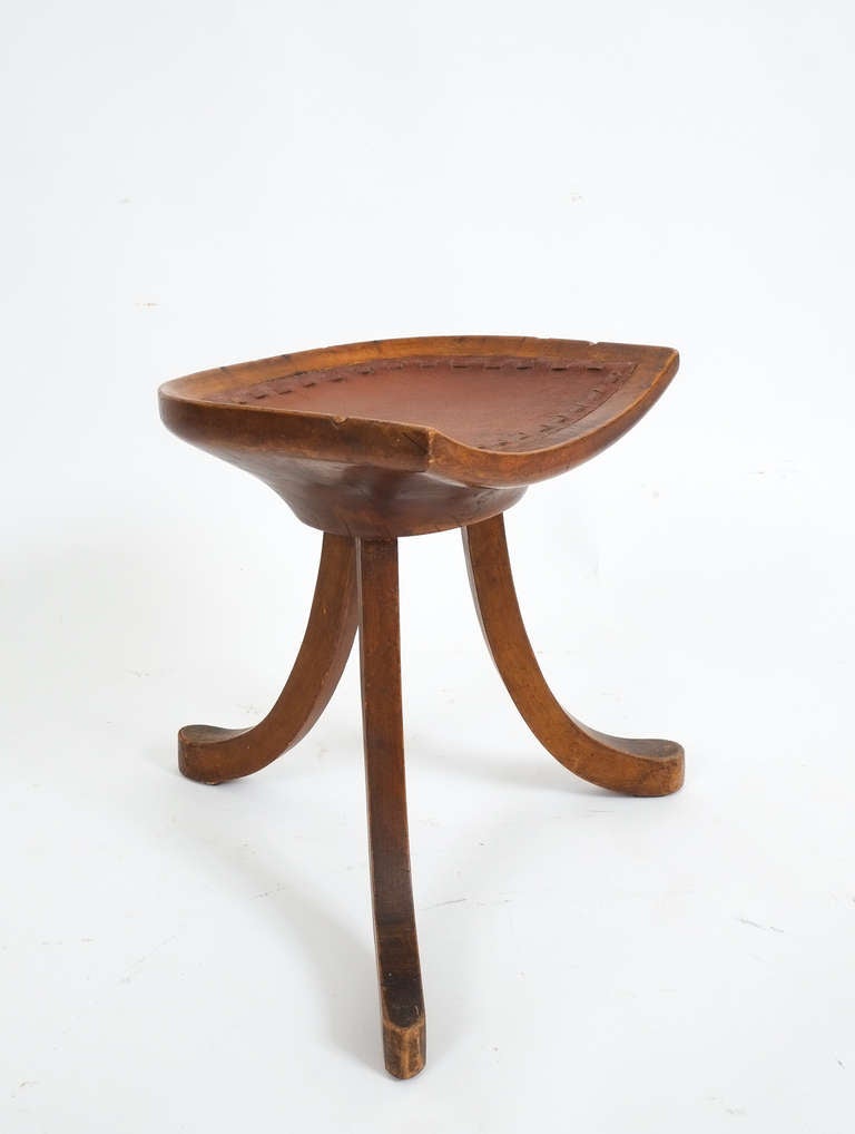 Egyptian stool 'Theben'by Adolf Loos circa 1910 made from oak and newly upholstered with vintage brown leather showing a nice patina. The carved seat has got two rather obvious dents on both sides and minor irregularities around the edge; otherwise