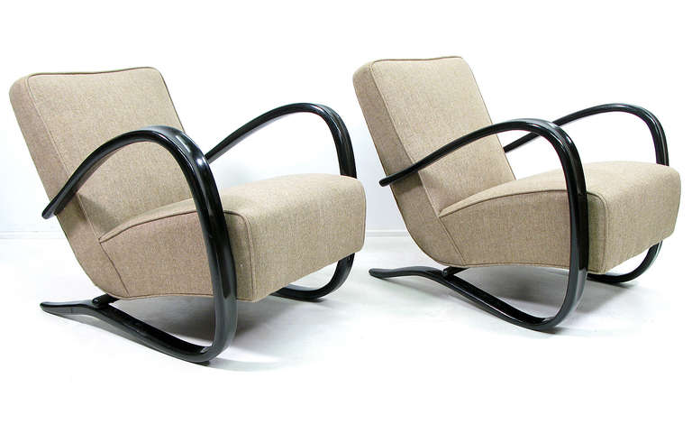 A pair of original 1930s armchairs by Jindrich Halabala. Newly upholstered in mushroom-coloured tweed, they are fine examples of Art Deco design.

Amongst the most celebrated Czech furniture designers of the 20th century, Halabala worked as head
