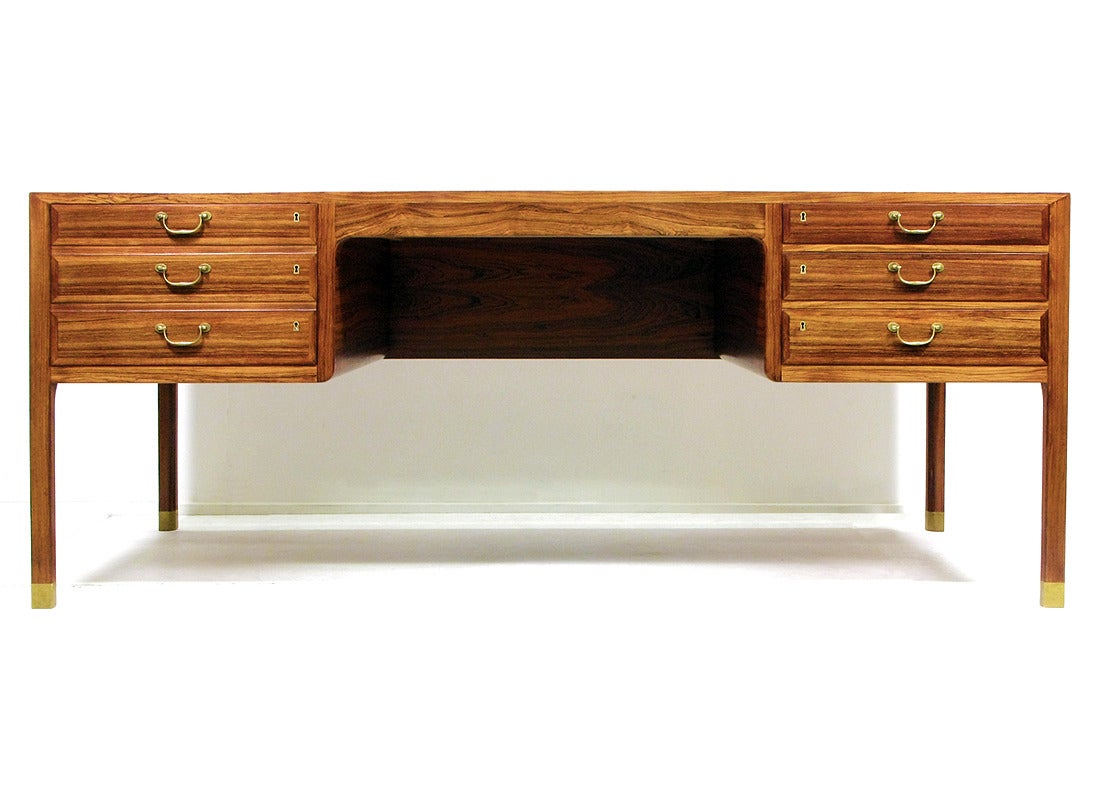 Width: 185cm, Depth: 92.5cm, Height 74cm, Chair cavity: 75.5cm wide

A fabulous rosewood desk by Ole Wanscher for A J Iversen, circa 1950. 

It has three deep drawers to the right, extensive filing drawer to the left and a pull-out writing