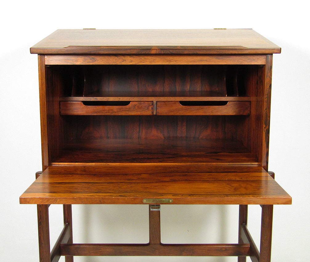 An elegant 1960s rosewood secretary by Arne Wahl Iversen. 

This versatile secretary can be used either standing or seated, the angled top providing a lectern function.

With original key, on sculptural legs, it provides ample storage. 

The