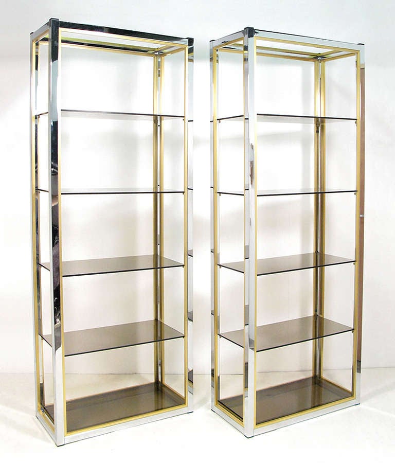 A pair of tall 1970s etageres in chrome and smoked glass by Italian manufacturer Zevi.  These can be purchased individually if required. Please enquire  if this is the case.  In excellent vintage condition, the chrome bright and untarnished with