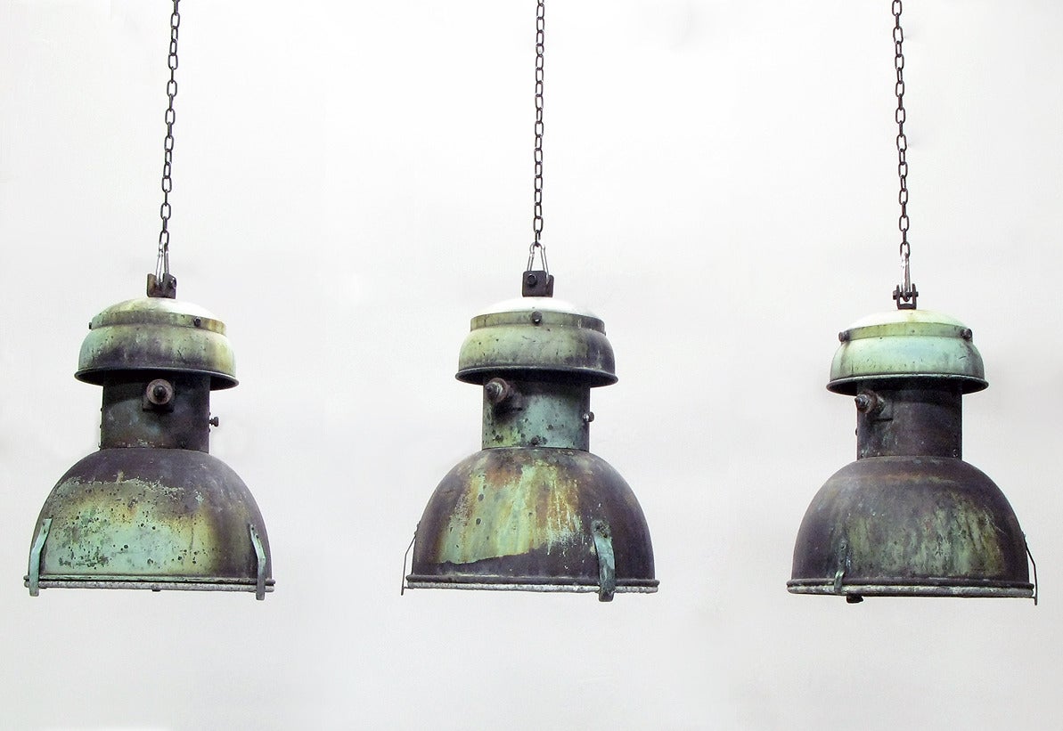 A beautifully patinated 1930s copper hanging street lamp from Franklin Rooseveltlaan in Brussels, Belgium.

Six are available.
 
On long chains, with new bulb holders they are rewired with black braided wire and are ready install and to