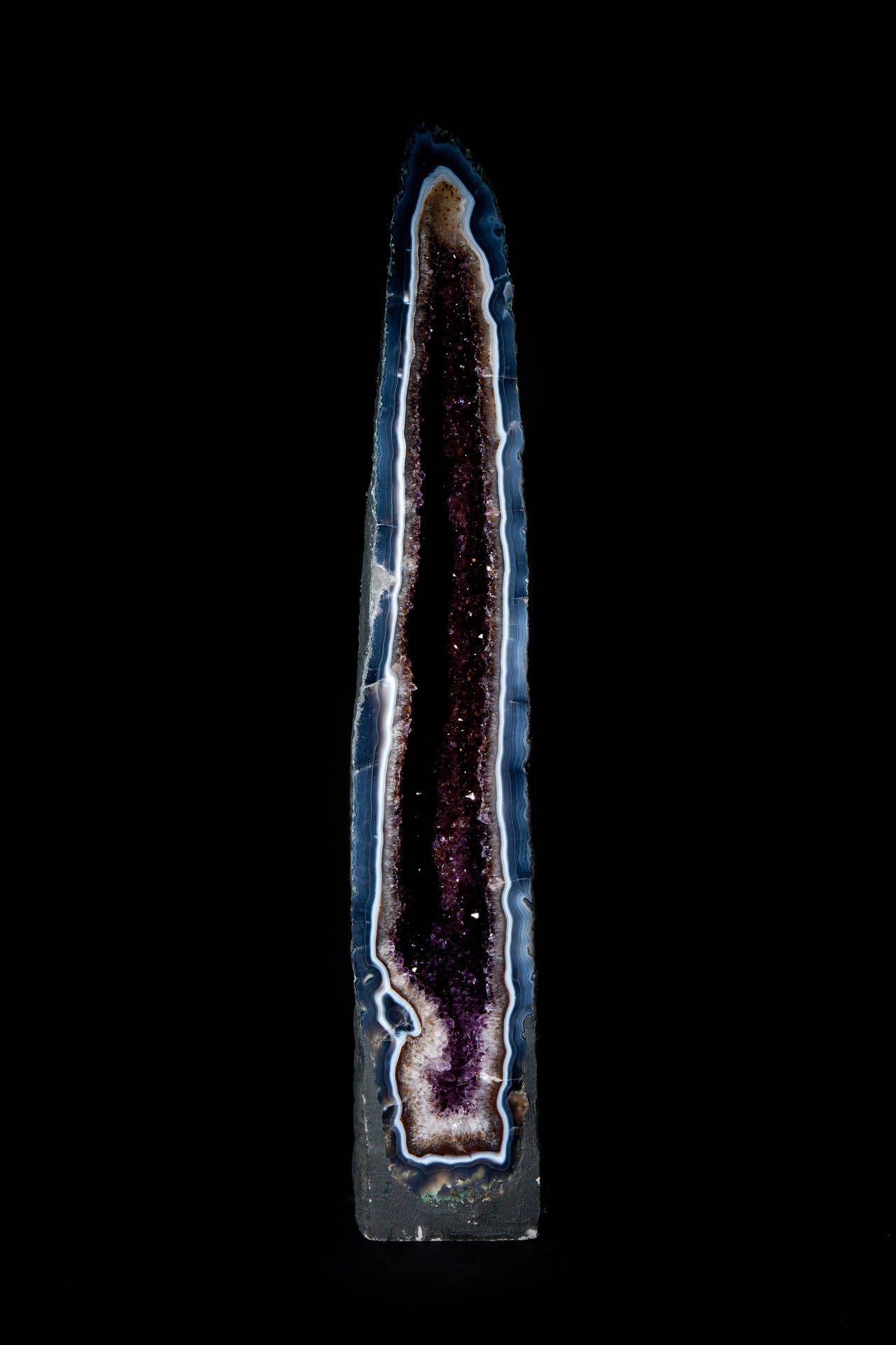 This is a fine example of the popular Amethyst geode. This piece has striking Agate bands around the edge of the structure and rare Smokey quartz crystals grouped within the Amethyst centre. One of the most unusual examples of Amethyst geodes we