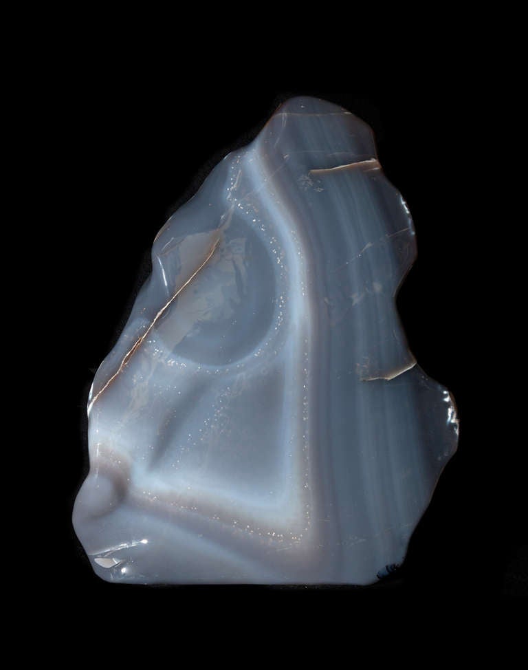 A large polished agate freeform. This freestanding Brazilian agate has two interesting dimensions to it: serene blue-grey bands on one face, dramatic white natural inclusions on the other. This is a truly unique piece of natural art.

About

Since