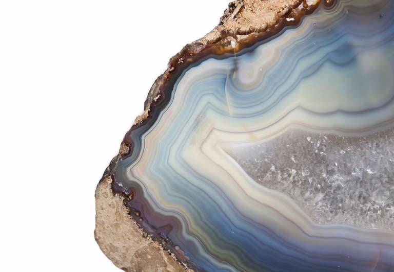 A large polished agate slice. This Brazilian agate has two interesting dimensions to it: serene blue-grey bands and quartz crystal through the centre of the piece.  Believed to be Hundreds of thousands to millions of years old

- - -

About Dale