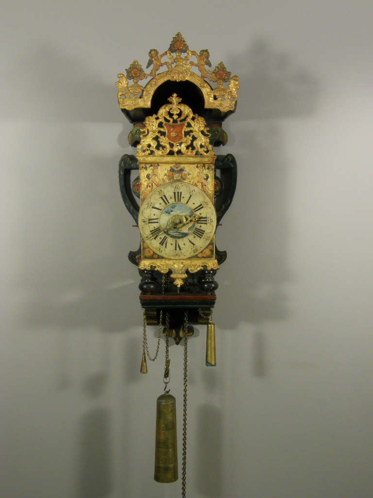 polychrome painted and gilt dial with protruding chapter ring showing Roman chapters, brass hands and alarm pointer, with deities flanking the date aperture, well made weight driven brass posted movement with verge escapement, countwheel half hour