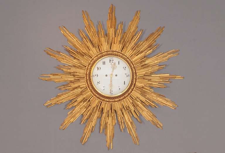 A Very Large and Rare Dutch Giltwood Sunburst Quarter Striking Wall Clock circa 1770, with Dutch striking on two bells, verge escapement, 8-day movement, circa 16 inch (40 cm.) dial and total diameter of circa 50 inch (125 cm.), Arabic numbering and