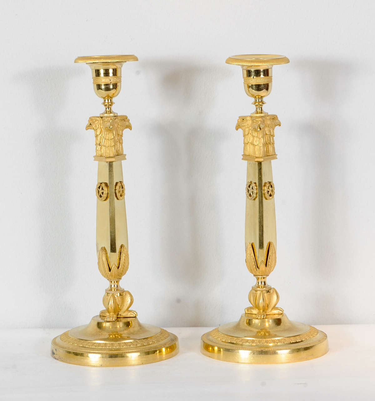 A nice pair of Russian Empire candlesticks, circa 1810, with eagle heads and claw feet.