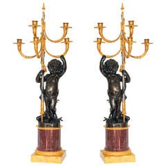 A pair of French gilt and patinated bronze 5-light candelabra on porphyry base
