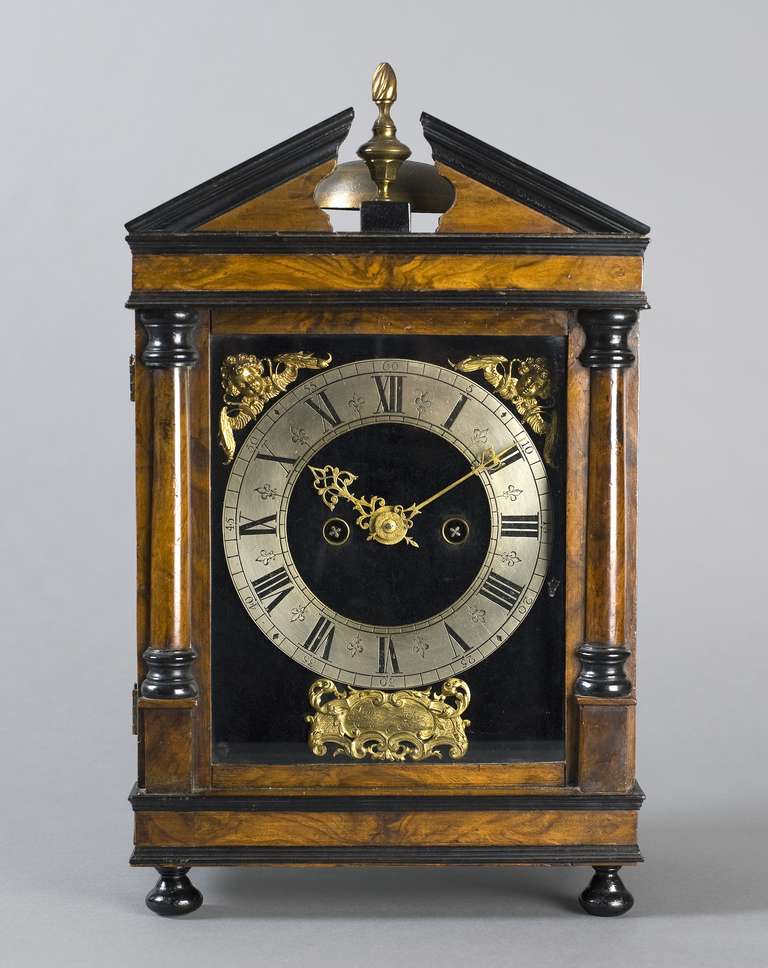 signed in a cartouche on the dial 'Simon Lachez Utrecht Fecit', c. 1690. The walnut and ebony-veneered case has a broken architectural top, with a flambeau finial on a base in the gap. The door is flanked by two plain pillars with ebony capitals and