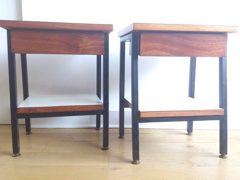 an elegant pair of petite French night stands or bouts de canapé in mahogany veneer and formica.  Formica features 