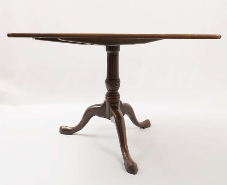 Early 19th century Georgian mahogany tilt-top table with a tripod base. Has an interesting scalloped corner the mahogany wood is beautifully faded.