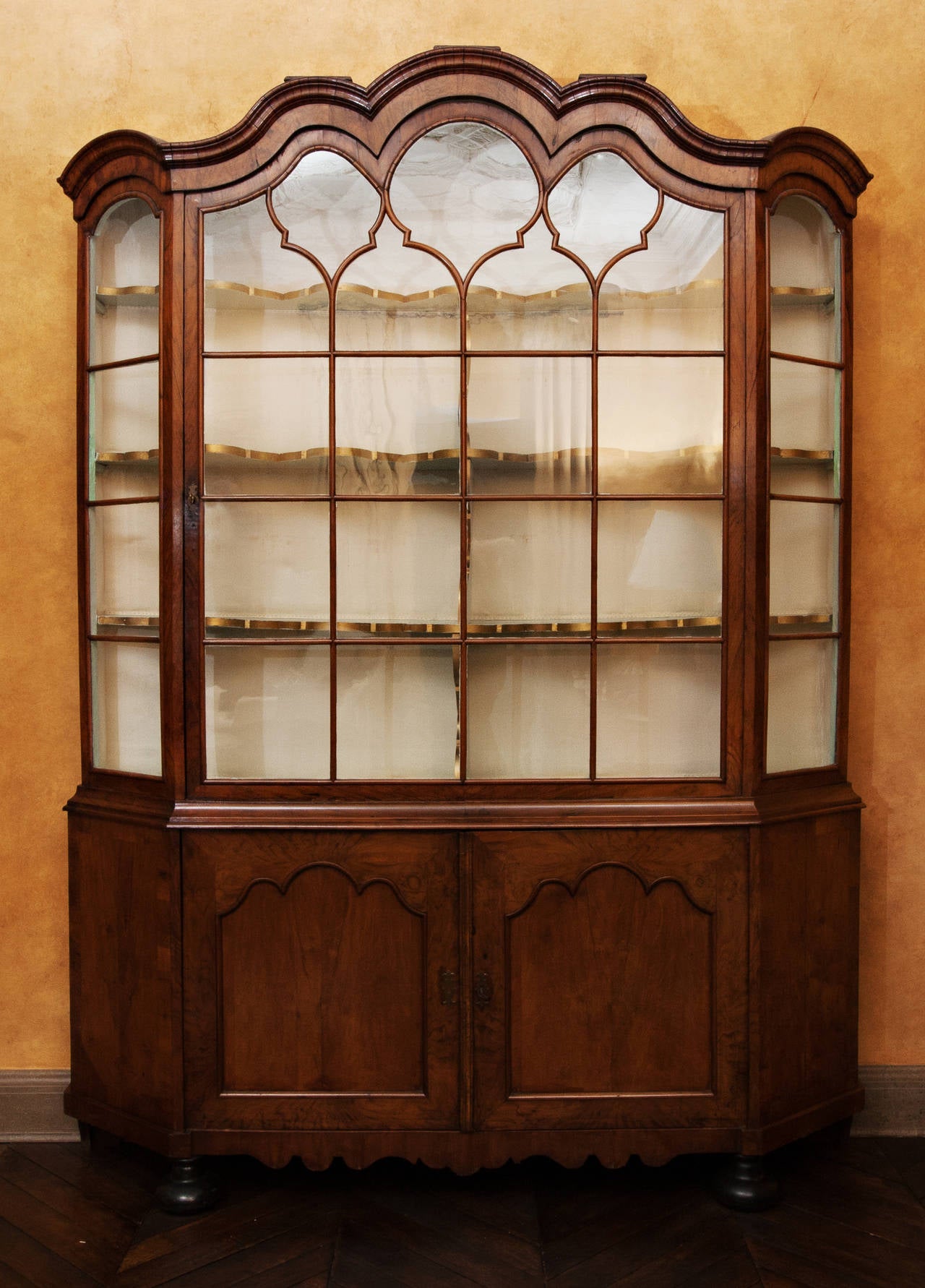 This is a beautiful 18th Century, circa 1720, Dutch Burl Walnut Breakfront with one single door that has the original glass in the panes.  It has three scalloped shelves with gold trim behind a single glass door with lock and key and has an