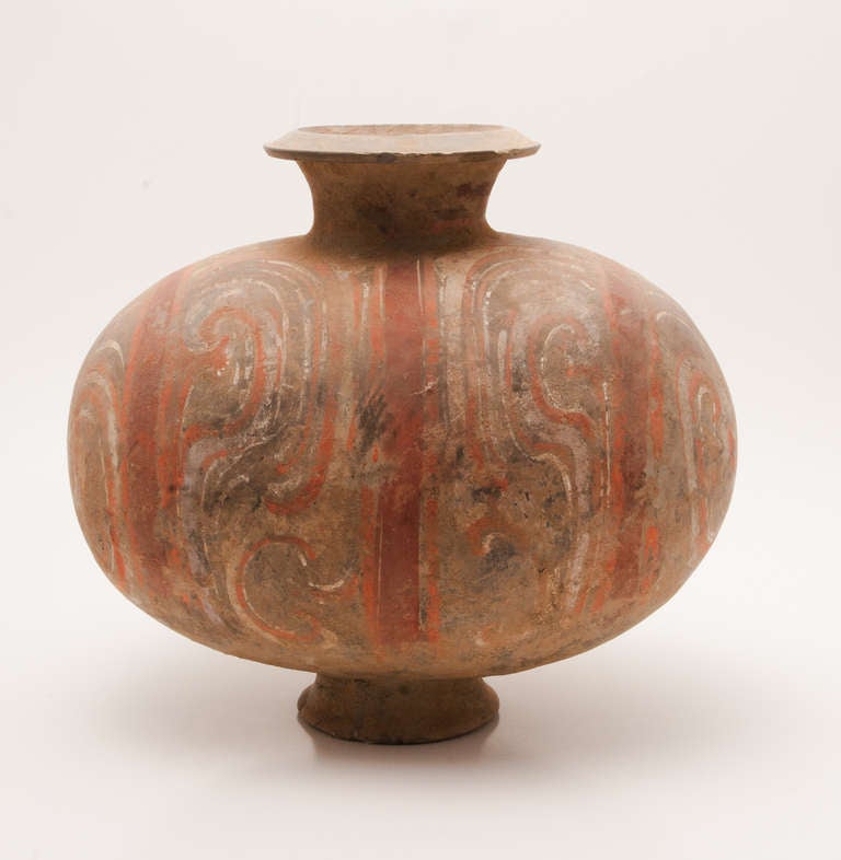 A fine pair of Han Dynasty cocoon jars (206 BC-220 AD) distinguished by its cold-painted colors of red, white and pink on a dark clay body. The distinctively plump, ovoid form of this jar, imitating the shape of a silkworm cocoon, has a good