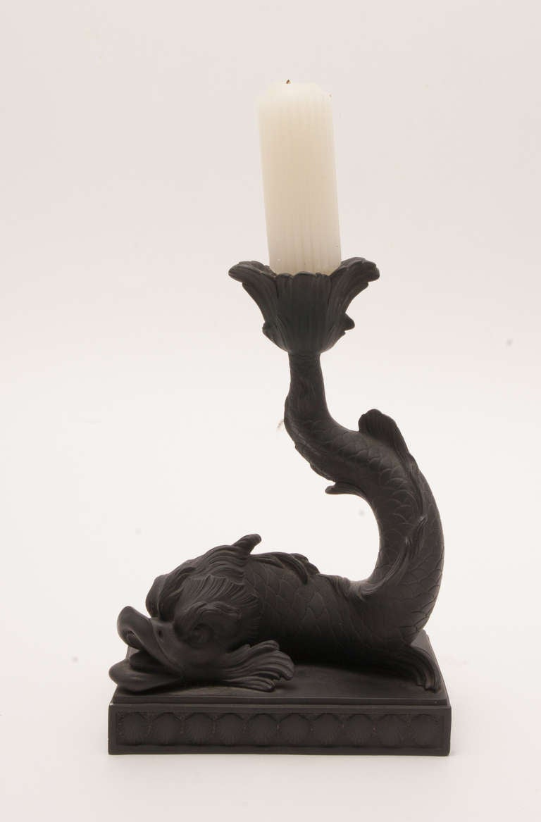 A beautiful black basalt dolphin candlestick made by Wedgewood. Popular during the neoclassical revival in the late 18th-early 19th century, England. The dolphin form was often represented in ancient Greek and Roman Art.