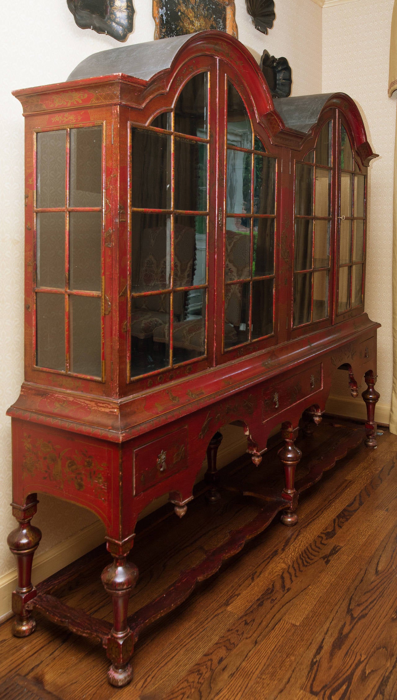 Red Lacquer and Chinoiserie Double Bonnet Cabinet with four doors and stretchers on the bottom