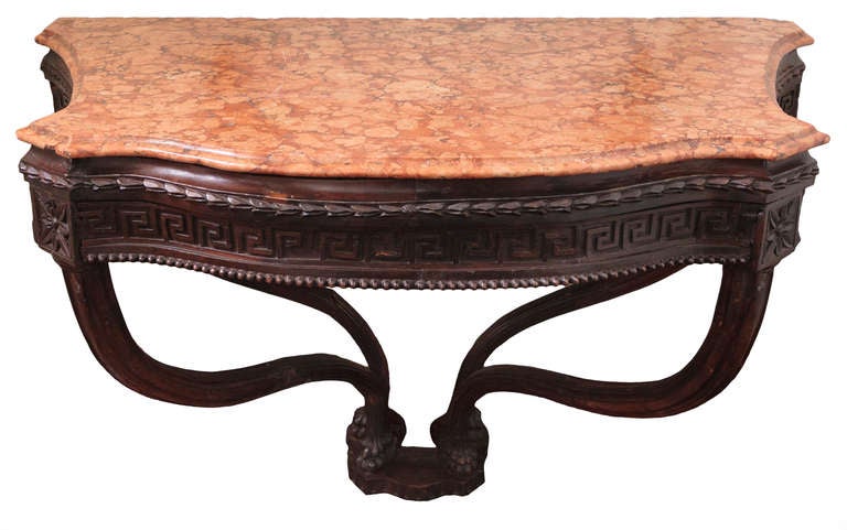 This 18th Century Italian console is carved in walnut and the origin is Rome, circa 1770. It has beautiful graceful legs with lion paw feet that rest on a base. The marble-top is original and is a beautiful terracotta color with a beveled edge in a