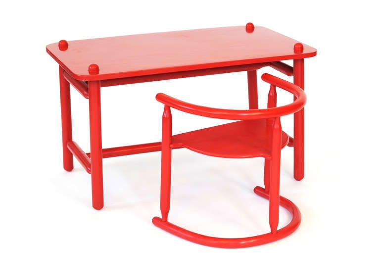 Unique children's red table and armchair designed by Karin Mobring for Ikea, Sweden, 1963.

Armchair can be flipped for two different heights (one for smaller child, one for larger child).

Table: H 17 in, W  29.5, D 18 in
Chair: H 14.25 in,  W
