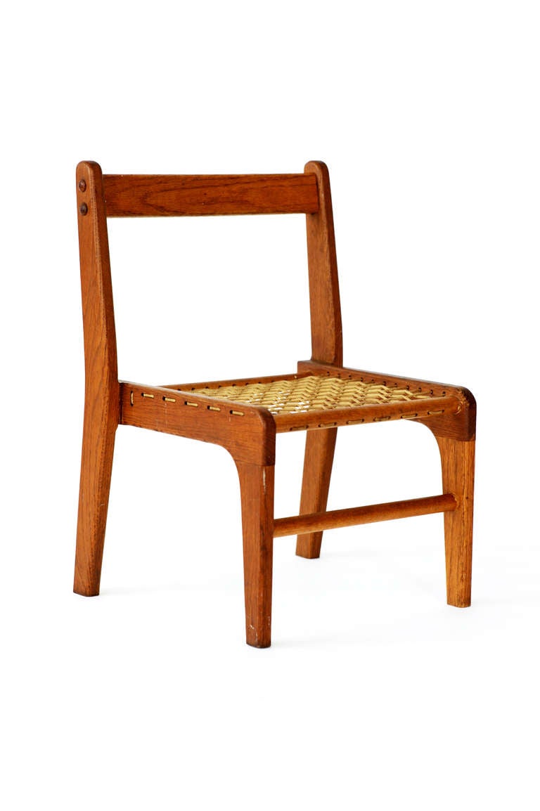 Children's teak chair with original woven rope. Exceptional piece.