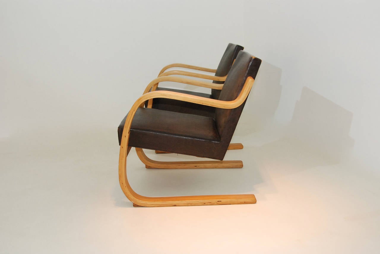 Pair of Cantilavered armchairs 345/402 by designer Alvar Aalto, produced by O.y. Huonekalu-ja Rakennustyötehdas A.b.,Turku,for Artek , Helsinki 30's
Frame in bent laminated birch, 
Upholstered with the original leather