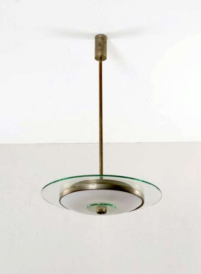 Pendant lamp.  Nickel-plated metal, hard beveled glass disk, curved, milk glass thin diffuser.  Production Luig iFontana & C.