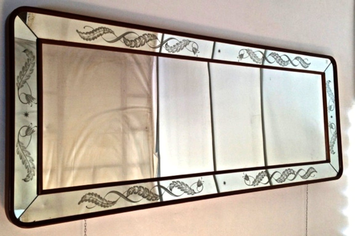 An important 1940's mirror with sandblasted engraved decorations .Heavy wooden frame, two tiny flaws that  hardly  be  seen live.
This mirror can be hang horizontally or vertically