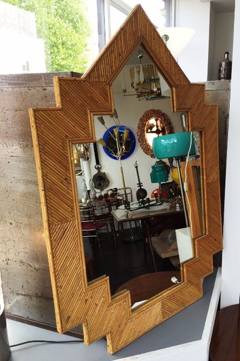 Late 1970s mirror in rattan, large size and interesting shape typical from the period.
