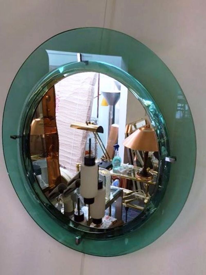 Asymmetric emerald round mirror.