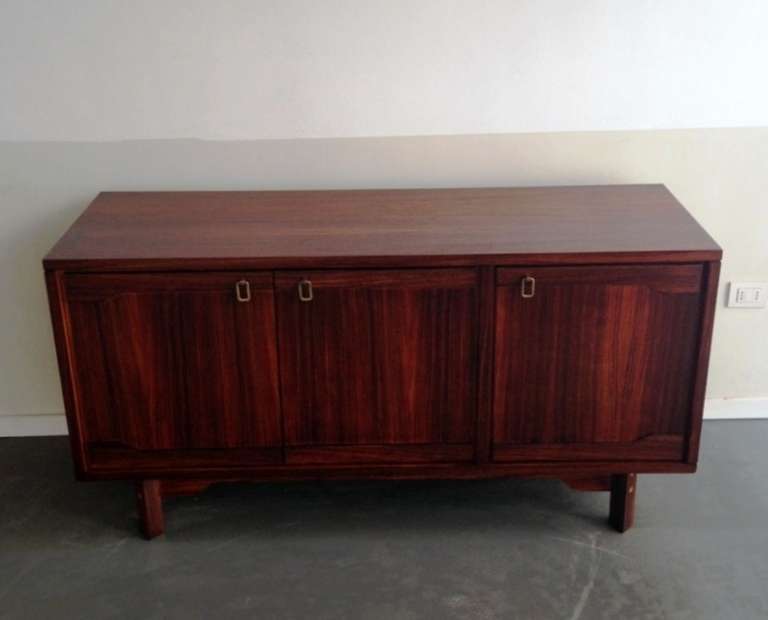 Sleek pair of rosewood sideboard with brass handles , 1 cabinet with drawers and 1 cabinet only doors, inlaid details on the base .