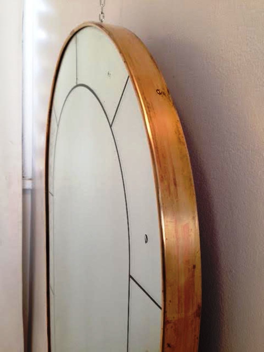 Elegant late 1930s mirror with brass frame, half rounded shape, original in all his parts with small dots of silver missing.
