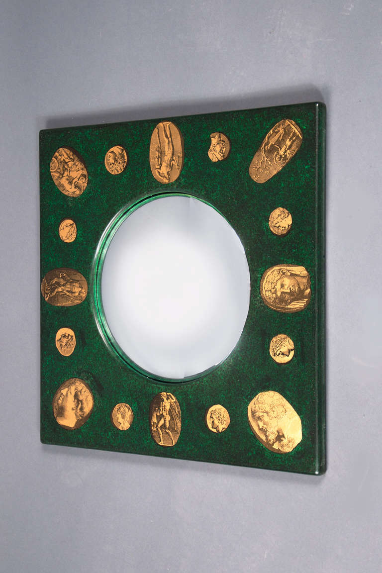 Mirrored convex glass, framed in lithographed wood, depicting numerous classical cameos. Original label on the back. 

 