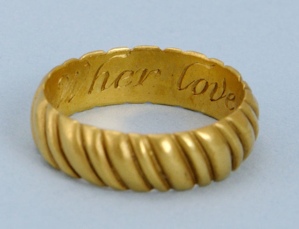 Very eye-catching, chunky and heavy gold posy ring, circa 1700. Made of a very high grade of gold and with a pale lemon colour. The outside of the ring is decorated with diagonal ribbing. 

The contemporary inscription on the inside of the ring is