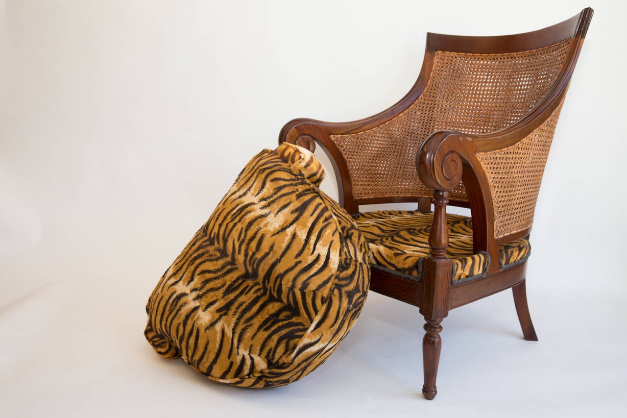 An opulent, comfortable and large neo-classical armchair in the French Empire Style, upholstered in fake tiger skin. The double caned fo the back is quite typical of Maison Jansen productions of the 1960s.
For any details or shipping infos please