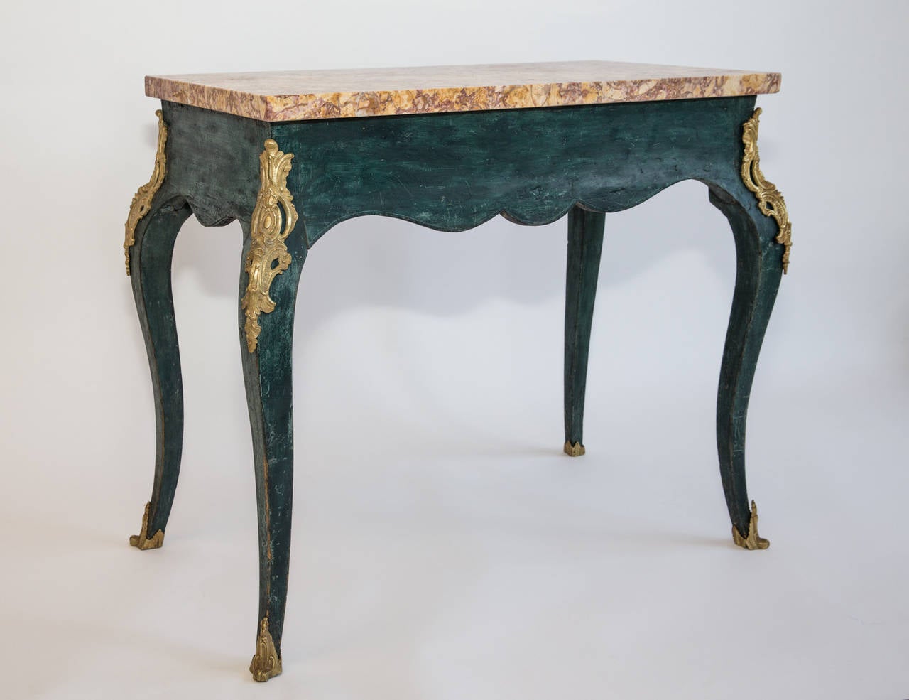 A very elegant and small ormolu mounted cabriole center table ( Louis XV style- France 19thc) with a beautiful marble top.
For any additional or shipping information please do not hesitate to contact us directly.