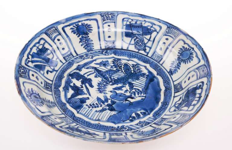 A porcelain charger from the 17th century with beautiful blue decorations of ducks in a pond. This item symbolizes wealth and good luck.
