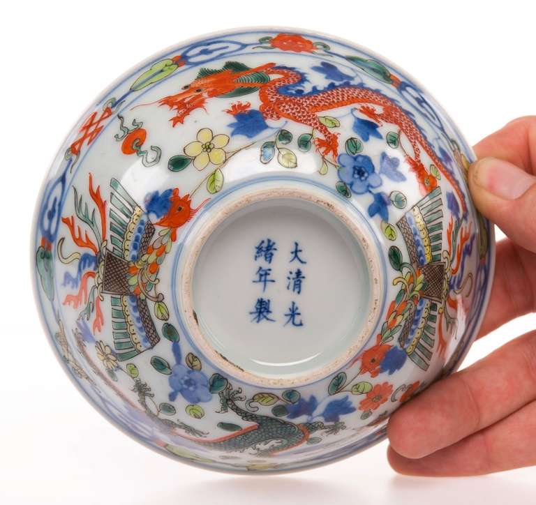 A porcelain bowl with beautifully vivid decorations of dragons and phoenixes on the outside. And another dragon on the inside. 

A 6-character Qianlong mark on the base and of the period.