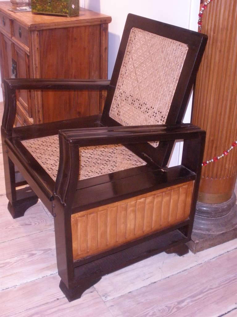 Pair of deco-period rosewood and satinwood caned chairs.  Back rest will fold down for easier storage.  Nice carved details and exotic hardwoods.  Colonial British.  Great for veranda and porch use as well.