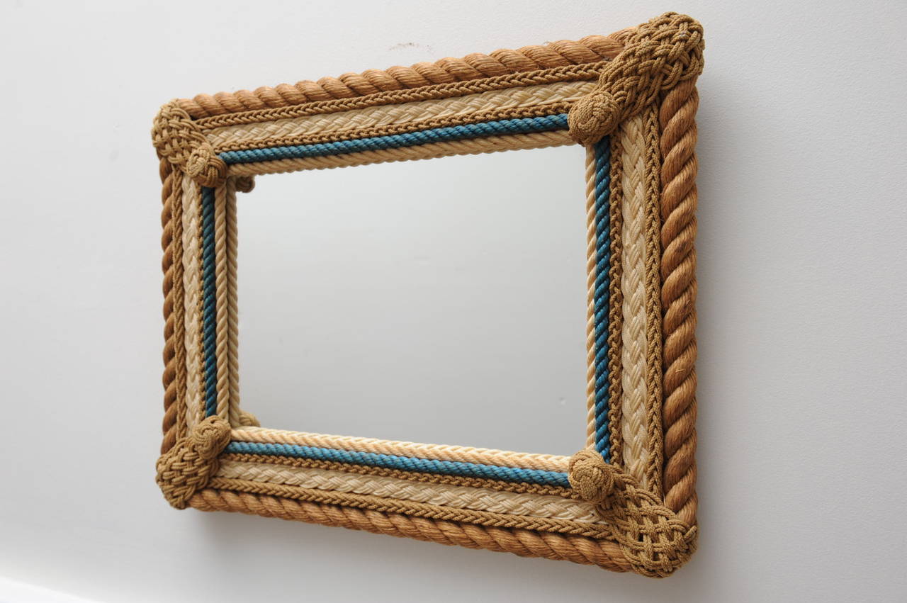 Hand knotted rope work mirror from the 1940's featuring various knot designs.  American.