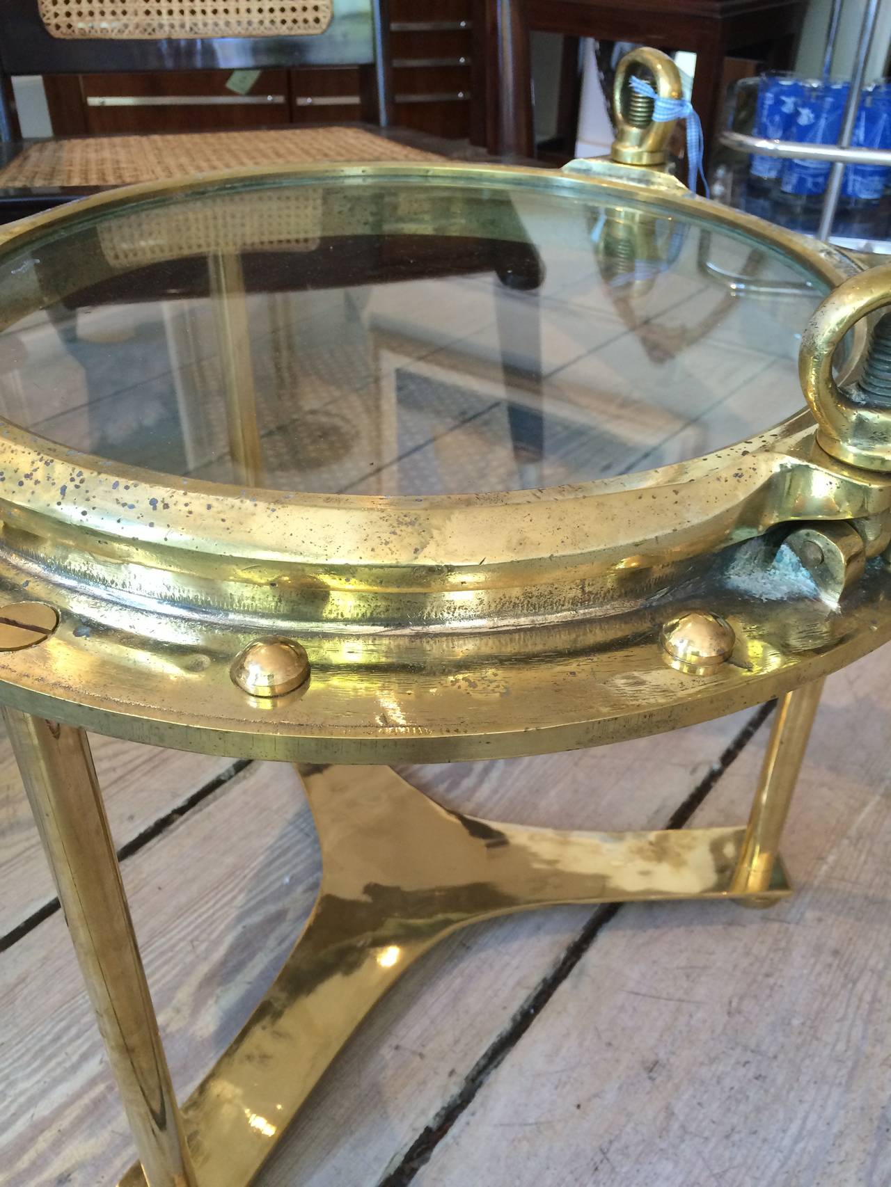 A fabulous pair of solid brass portholes from a merchant ship converted to tables complete with a working window and re-installed rivets. Can also be disassembled for easy transport.

Nautical antiques and artifacts located on Nantucket Island.
