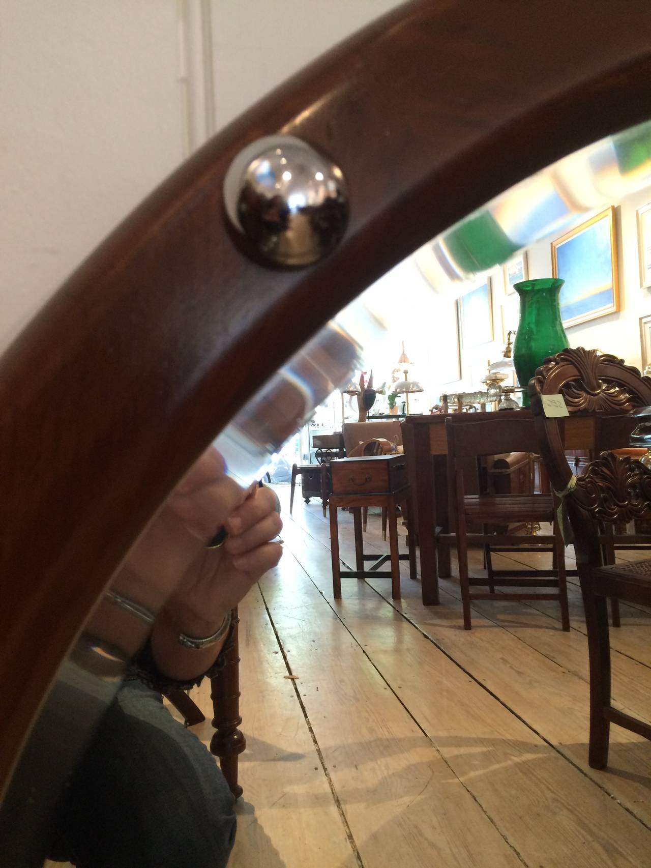 A teak mirror from a ship's stateroom with chrome rivets and beveled mirror.

Nautical Antiques and Artifacts located on Nantucket Island.