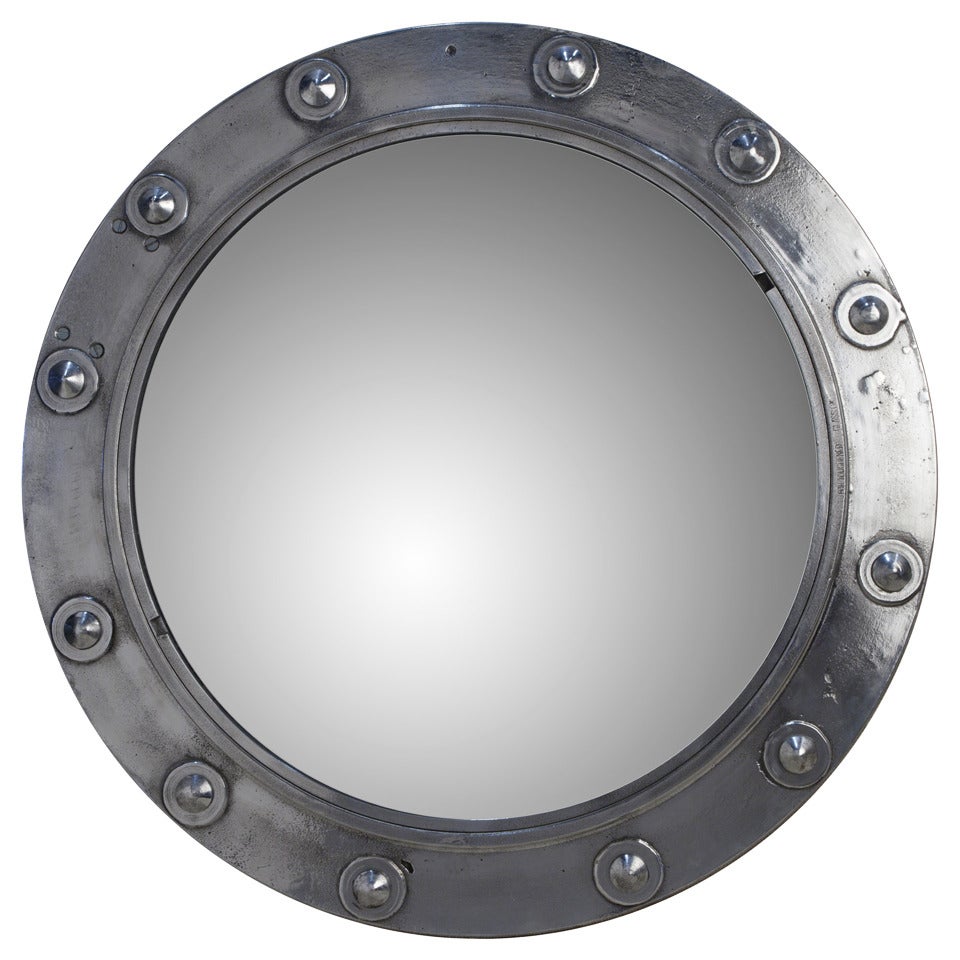 This is an original chrome porthole from a working ship. It has been converted to a mirror with bevelled glass.
