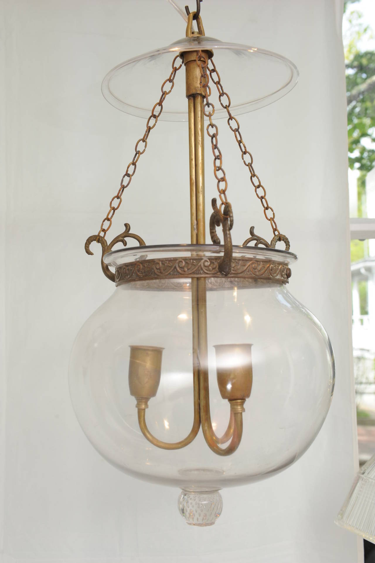 A fabulous, unusual hall lantern with lovely brass hardware, complete with smoke cap. Electrified for modern use, handblown, English, from the late 1800s.

Bell jar hall lanterns, stop located on Nantucket.