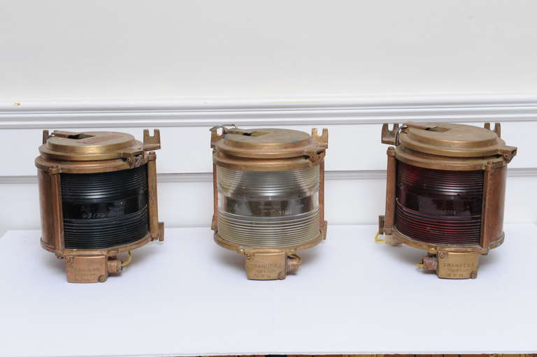 This is a rare set of three ship navigational lights...port, console and starboard.  Made in cast brass with Fresnel lenses by Tranberg Co. from Norway and are dated 1977.  These have been rewired for American use.  In very good condition with some