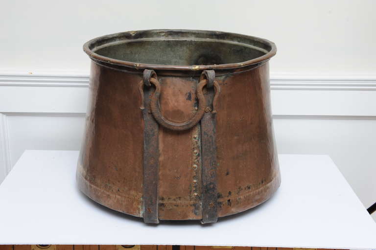 A beautifully hand-crafted copper urn with dovetailing sealed with bronze, bronze rivets and iron straps and handles.  No holes in the bottom and in very good condition.  Great for kindling and firewood, or as a planter, indoors or out.