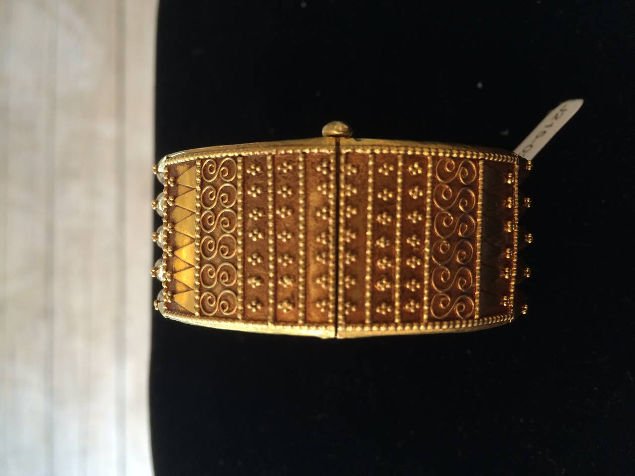 This is a spectacular 22K gold bracelet, hinged with a pull pin clasp.  It features fine granulation and filigree work .  Both the top and the bottom of the bracelet have this fine detailing.  The pin on the clasp has a stop so that it will not