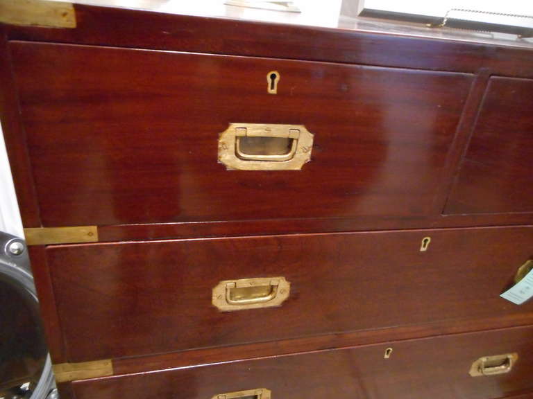 Petite size British Campaign rosewood chest of drawers in two parts with brass strap corners and flush drawer pulls, on turned feet.

Located on Nantucket Island.
Nautical Antiques and British Campaign Pieces.