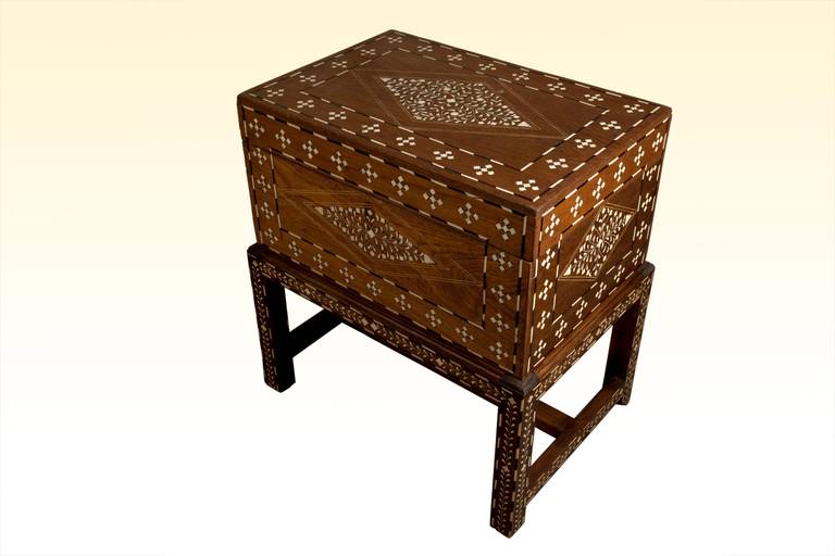 Teak chest with rosewood and bone inlay on a custom-made stand. Southeast Asia or Morocco, circa 1970s. Very intricate inlay work, small pieces with beautiful patterning.