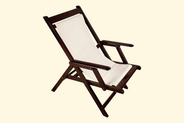 Pair of Mid-century Colonial British Campaign folding rosewood and canvas deck chairs.  Includes both the blue and green stripe fabric and matching, detachable pillow (ties onto back); and white canvas seat.  Easily swapped out or replaced.  Folds